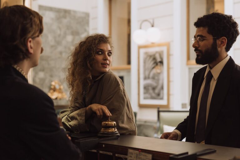 Hotel guest checking their phone in a modern hotel lobby, highlighting the need for guest connectivity beyond wifi