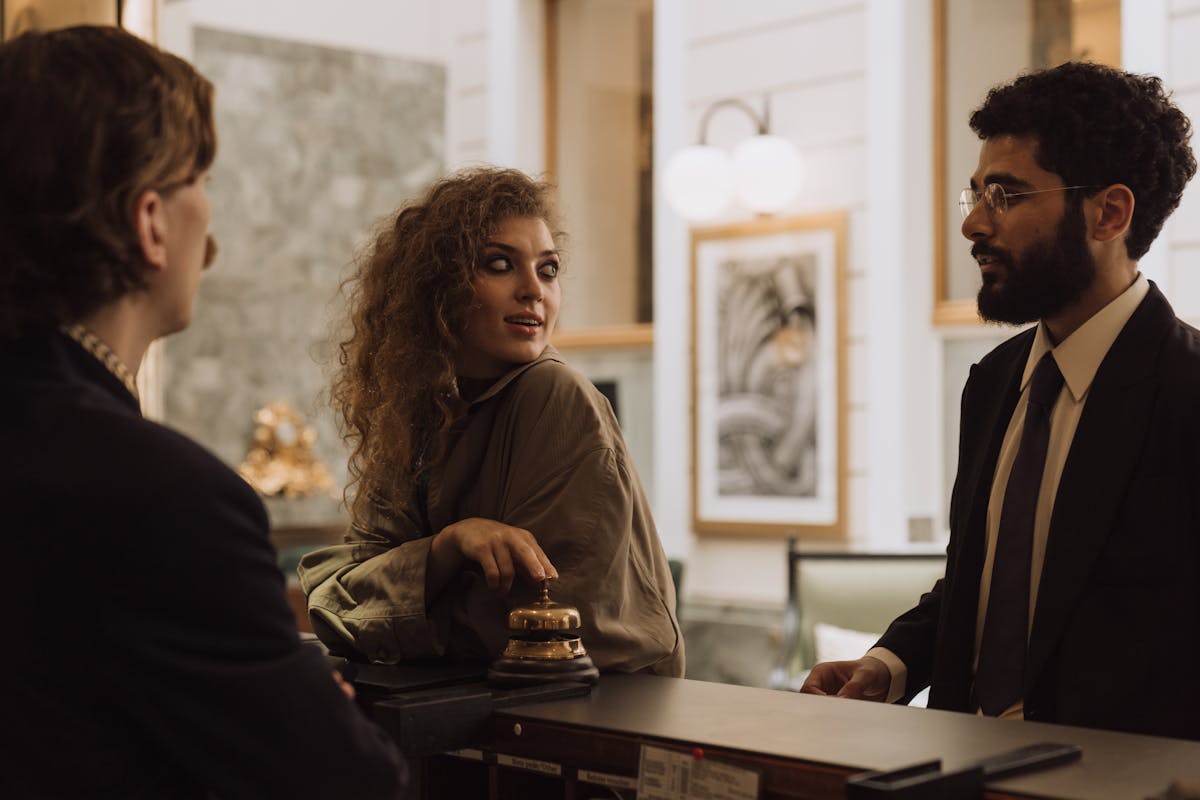 Hotel guest checking their phone in a modern hotel lobby, highlighting the need for guest connectivity beyond wifi