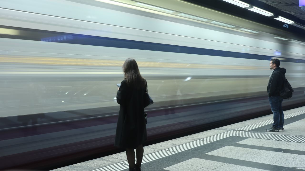 Travellers on a Zurich subway platform, where an eSIM-only iPhone needs a travel data plan to get online