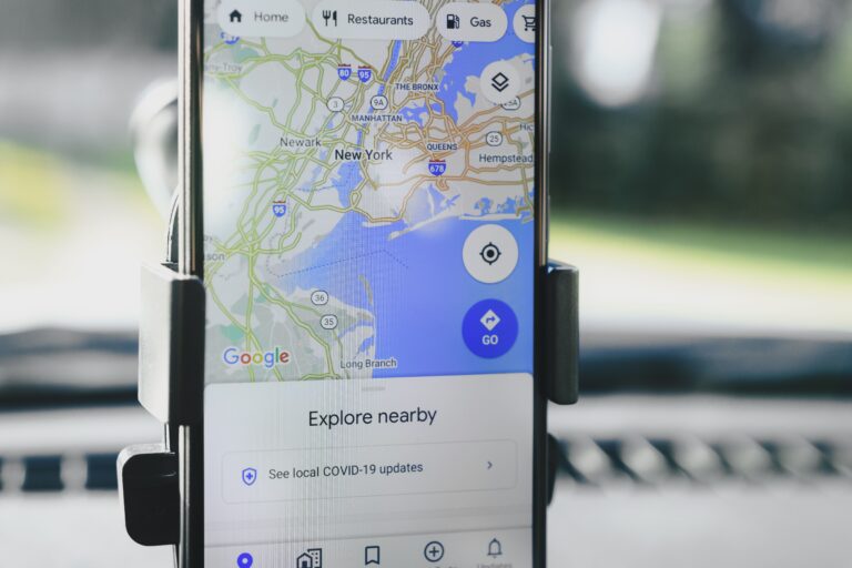 Smartphone in car mount showing GPS map navigation — Google Maps needs data for real-time directions abroad