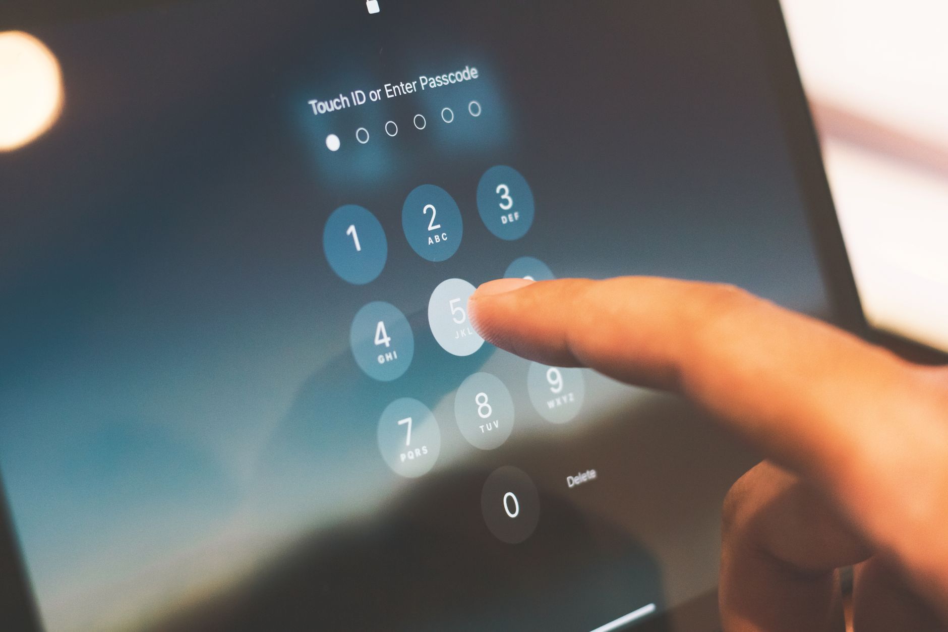 Finger entering a verification passcode on a smartphone screen after a number was rejected for SMS verification